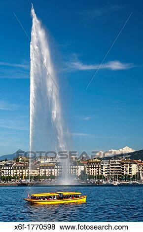 Geneva boat taxi of the company? Mouettes Genevoises? passing by the monumental water fountain Jet d? Eau at the Lake Geneva lakefront, snowcovered Mont Blanc mountain range in neighbouring France behind, Geneva, Switzerland View Large Photo Image Stock Photo - Geneva boat taxi of the company? Mouettes Genevoises? passing by the monumental water fountain Jet d? Eau at the Lake Geneva lakefront, snowcovered Mont Blanc mountain range in neighbouring France behind, Geneva, Switzerland. Fotosearch