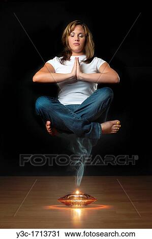 Genie levitation - woman floating in air over smoking oil lamp View Large Photo Image Stock Image - Genie levitation - woman floating in air over smoking oil lamp. Fotosearch