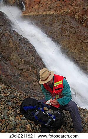 Stock Image - Geologist doing field work, Hudson Bay mountain, Smithers, British Columbia.. Fotosearch