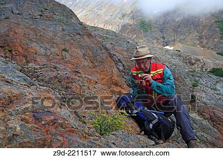 Stock Photo - Geologist doing field work, Hudson Bay mountain, Smithers, British Columbia.. Fotosearch