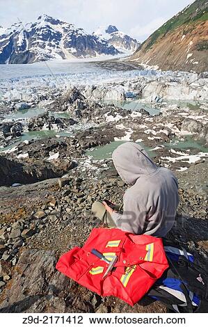 Geologists assistant exploring for minerals, Salmon Glacier area, Stewart, British Columbia. View Large Photo Image Stock Image - Geologists assistant exploring for minerals, Salmon Glacier area, Stewart, British Columbia.. Fotosearch