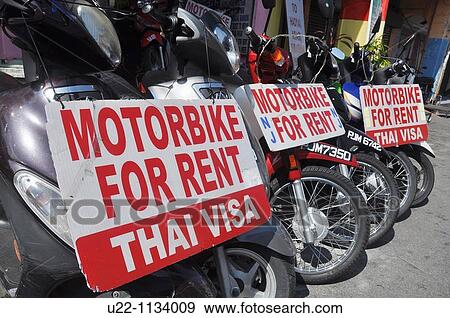 George Town, Penang (Malaysia): motor-bikes for rent along Lebuh Chulia, at an agency that offers also a Thai visa service View Large Photo Image Stock Photo - George Town, Penang (Malaysia): motor-bikes for rent along Lebuh Chulia, at an agency that offers also a Thai visa service. Fotosearch