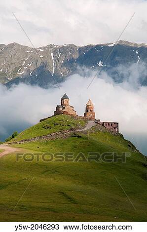 Stock Image - Gergeti Trinity (Tsmina Sameba) Church in the High Caucasus above Kazbegi, Georgia.. Fotosearch