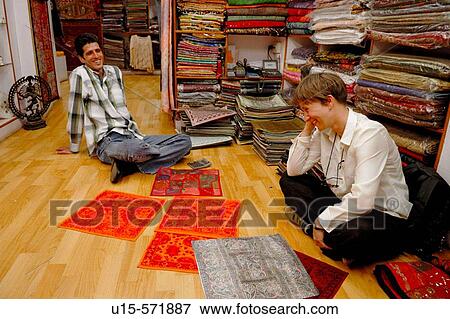 German female tourist negotiating prices for typical indian fabrics in a small boutique in the jewish part of Cochin (Kochi). Cochin, Kerala, India 2005. View Large Photo Image Stock Photo - German female tourist negotiating prices for typical indian fabrics in a small boutique in the jewish part of Cochin (Kochi). Cochin, Kerala, India 2005.. Fotosearch