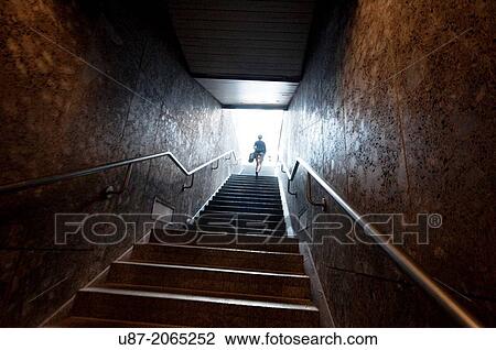 Stock Image - Germany, Bavaria, Munich, Underground, Person Coming Out of the Metro.. Fotosearch