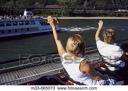Germany - Cruise down the Rhine river on board of Rhine Emerald boat. Tourists on the deck. View Large Photo Image Stock Image - Germany - Cruise down the Rhine river on board of Rhine Emerald boat. Tourists on the deck.. Fotosearch