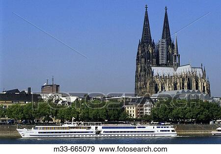Germany - North Rhine-Westphalia - Cologne. Cruise down the Rhine river. Rhine Emerald boat in front of the Cathedral. View Large Photo Image Stock Photo - Germany - North Rhine-Westphalia - Cologne. Cruise down the Rhine river. Rhine Emerald boat in front of the Cathedral.. Fotosearch