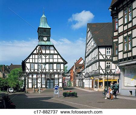 Stock Photo - Germany, Uslar, Schwuelme, Ahle, Solling, Weserbergland, Lower Saxony, city hall with clock tower, half-timbered houses, pedestrian zone, people. Fotosearch