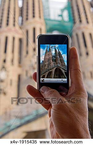 Getting picture with iPhone to Sagrada Familia Cathedral by Gaudi, Barcelona, Catalunya Catalonia Cataluna, Spain, Europe - M R View Large Photo Image Stock Photography - Getting picture with iPhone to Sagrada Familia Cathedral by Gaudi, Barcelona, Catalunya Catalonia Cataluna, Spain, Europe - M R. Fotosearch