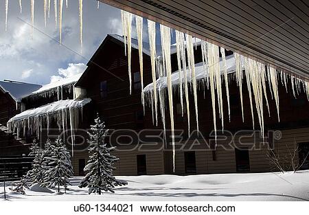 Stock Image - Giant icicles form during the winter at old Faithful's Snow Lodge at Yellowstone National Park, Wyoming. Fotosearch