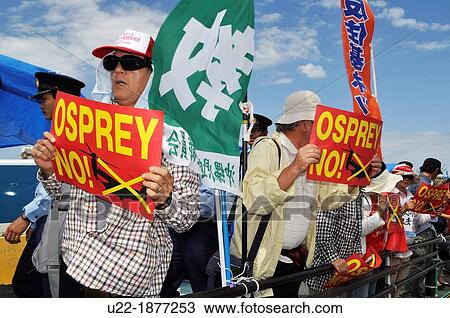 Stock Image - Ginowan, Okinawa, Japan, people protesting outside Futenma base against the American military occupation of Okinawa and the use of V-22 Osprey helicopters. Fotosearch