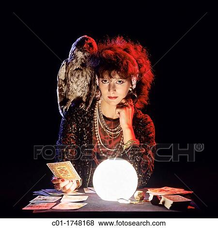 Gipsy fortune teller with an owl on her shoulder, tarot cards and lit crystal ball View Large Photo Image Stock Photo - Gipsy fortune teller with an owl on her shoulder, tarot cards and lit crystal ball. Fotosearch