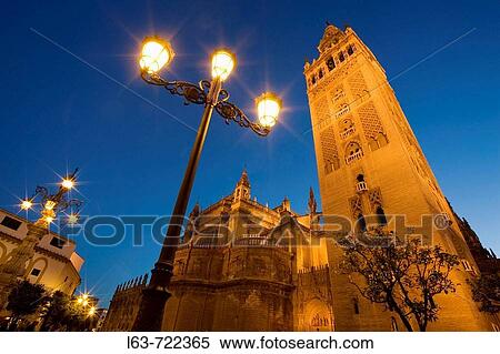 Stock Photography - Giralda tower and cathedral at night, Sevillla. Andalucia, Spain.. Fotosearch