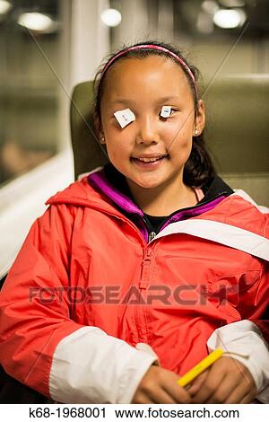 Girl, 10, playing with paper on her eyes. View Large Photo Image Stock Image - Girl, 10, playing with paper on her eyes.. Fotosearch