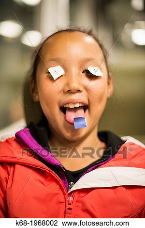 Girl, 10, playing with paper on her eyes. View Large Photo Image Stock Image - Girl, 10, playing with paper on her eyes.. Fotosearch