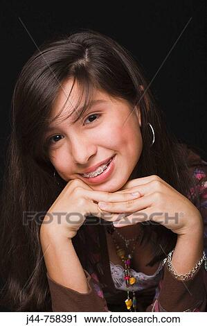 Stock Image - Girl 11-13 with braces, smiling, portrait. Fotosearch