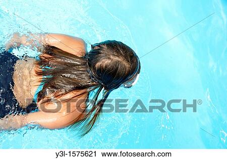 Girl 11 in swimming pool looking through water with goggles View Large Photo Image Stock Image - Girl 11 in swimming pool looking through water with goggles. Fotosearch