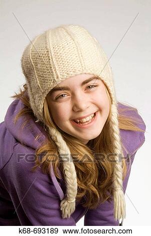 Girl, 12, in studio, wearing winter hat View Large Photo Image Stock Photo - Girl, 12, in studio, wearing winter hat. Fotosearch