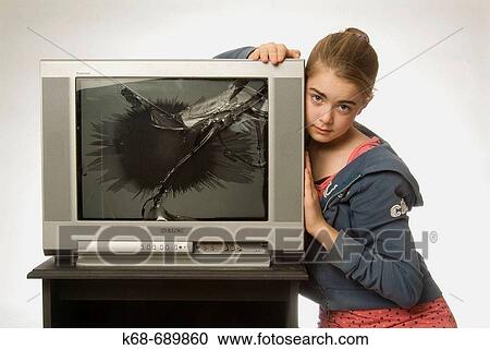 Stock Image - Girl, 12, with broken tv. Fotosearch
