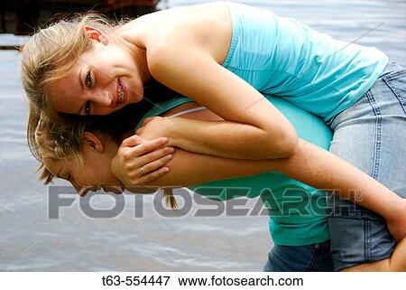 girl 13 carrying sister 18 on her back View Large Photo Image Stock Photo - girl 13 carrying sister 18 on her back. Fotosearch