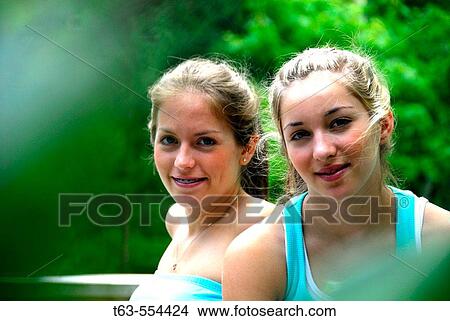 girl 13 girl 18 together on deck at cottage View Large Photo Image Picture - girl 13 girl 18 together on deck at cottage. Fotosearch