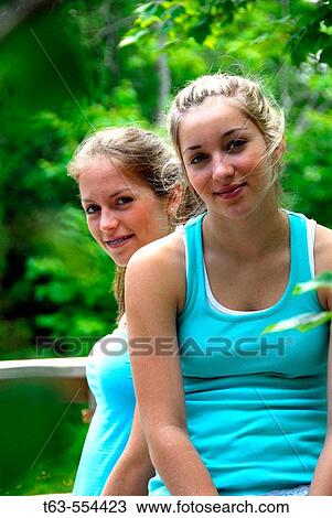 girl 13 girl 18 together on deck at cottage View Large Photo Image Stock Image - girl 13 girl 18 together on deck at cottage. Fotosearch
