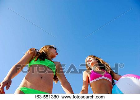 girl 13, girl 18 yrs holding beach ball and holding hands on beach, swimsuits View Large Photo Image Stock Image - girl 13, girl 18 yrs holding beach ball and holding hands on beach, swimsuits. Fotosearch