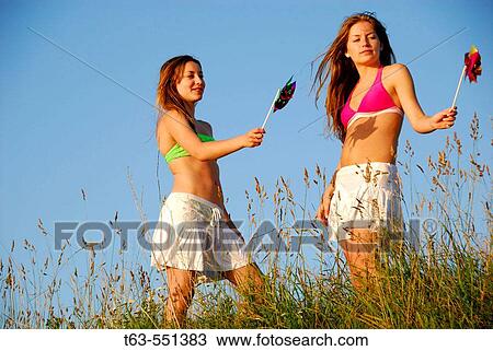girl 13, girl 18 yrs playing together with pinwheels View Large Photo Image Stock Image - girl 13, girl 18 yrs playing together with pinwheels. Fotosearch