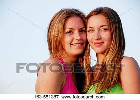 girl 13, girl 18 yrs standing together on beach in swimsuits View Large Photo Image Stock Photo - girl 13, girl 18 yrs standing together on beach in swimsuits. Fotosearch