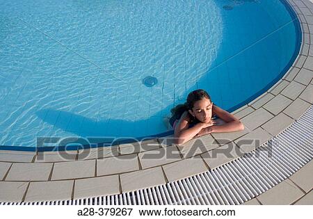 Girl (13 years) relaxing at edge of circular swimming pool. El Quesir. Egypt. View Large Photo Image Stock Photo - Girl (13 years) relaxing at edge of circular swimming pool. El Quesir. Egypt.. Fotosearch