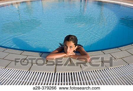 Girl (13 years) relaxing at edge of circular swimming pool. El Quesir. Egypt. View Large Photo Image Stock Photograph - Girl (13 years) relaxing at edge of circular swimming pool. El Quesir. Egypt.. Fotosearch