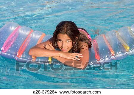 Girl (13 years) relaxing on airbed in swimming-pool. El Quesir. Egypt. View Large Photo Image Picture - Girl (13 years) relaxing on airbed in swimming-pool. El Quesir. Egypt.. Fotosearch