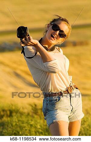 girl, 14, with camera, in a field in southern Alberta, Canada View Large Photo Image Picture - girl, 14, with camera, in a field in southern Alberta, Canada. Fotosearch