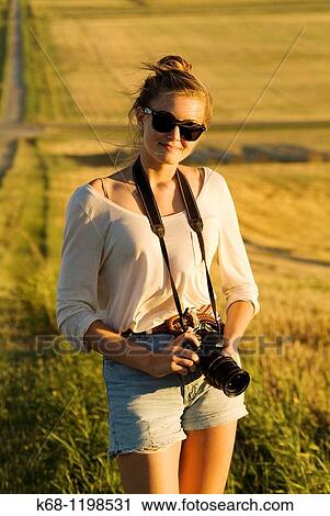 girl, 14, with camera, in a field in southern Alberta, Canada View Large Photo Image Stock Image - girl, 14, with camera, in a field in southern Alberta, Canada. Fotosearch