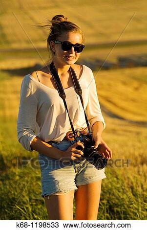 girl, 14, with camera, in a field in southern Alberta, Canada View Large Photo Image Stock Image - girl, 14, with camera, in a field in southern Alberta, Canada. Fotosearch