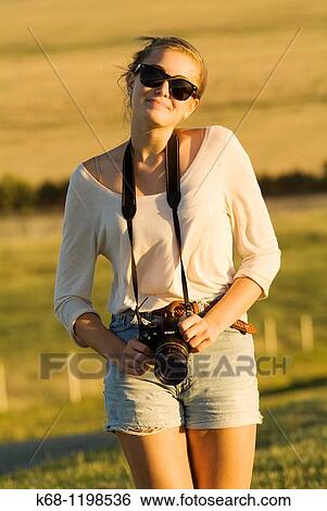 girl, 14, with camera, in a field in southern Alberta, Canada View Large Photo Image Stock Photograph - girl, 14, with camera, in a field in southern Alberta, Canada. Fotosearch