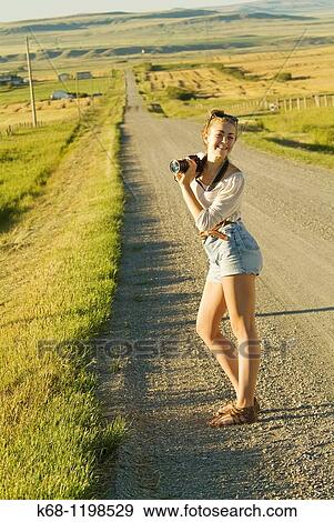 girl, 14, with camera, on a road in southern Alberta, Canada View Large Photo Image Stock Photo - girl, 14, with camera, on a road in southern Alberta, Canada. Fotosearch