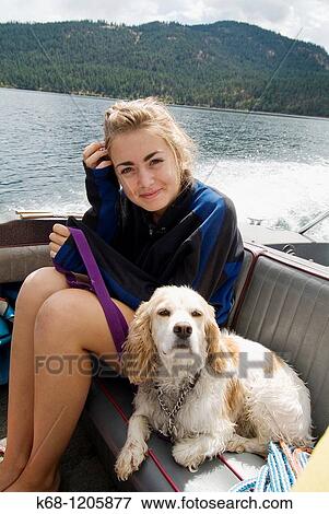 girl, 14, with her cocker spaniel, in a boat on a lake View Large Photo Image Stock Photo - girl, 14, with her cocker spaniel, in a boat on a lake. Fotosearch