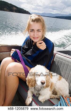 girl, 14, with her cocker spaniel, in a boat on a lake View Large Photo Image Stock Photo - girl, 14, with her cocker spaniel, in a boat on a lake. Fotosearch