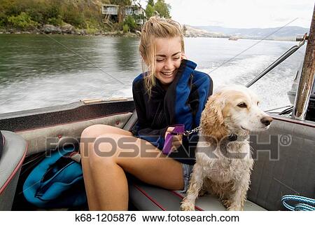 girl, 14, with her cocker spaniel, in a boat on a lake View Large Photo Image Stock Photograph - girl, 14, with her cocker spaniel, in a boat on a lake. Fotosearch