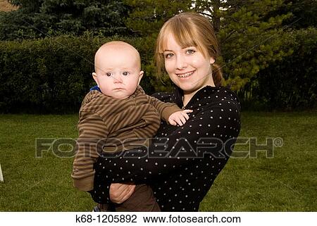 girl, 16, holding a baby, 6 months old View Large Photo Image Stock Image - girl, 16, holding a baby, 6 months old. Fotosearch
