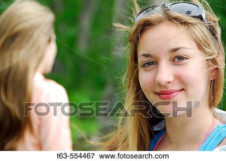 girl 18 in background, portrait of girl 13 at cottage View Large Photo Image Stock Photo - girl 18 in background, portrait of girl 13 at cottage. Fotosearch