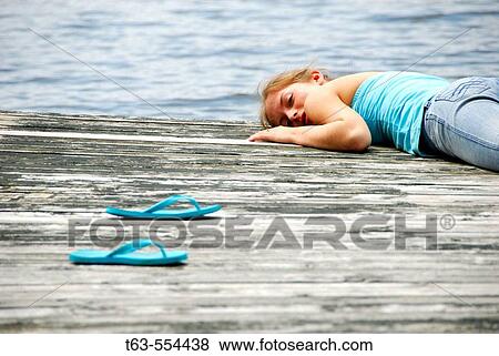 girl 18 laying on dock looking at camera View Large Photo Image Stock Photo - girl 18 laying on dock looking at camera. Fotosearch