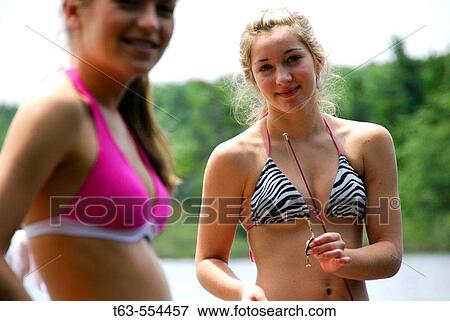 girl 18 standing with girl 13 with fishing rod on dock on lake View Large Photo Image Stock Photo - girl 18 standing with girl 13 with fishing rod on dock on lake. Fotosearch