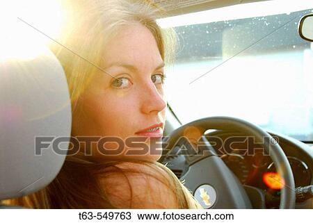 girl 18 yrs old driving car with evening sun peeking through. View Large Photo Image Stock Image - girl 18 yrs old driving car with evening sun peeking through.. Fotosearch