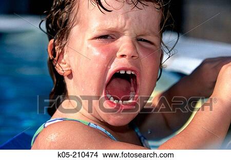 Girl (3 yr) screams with mouth wide open holding onto side of pool View Large Photo Image Picture - Girl (3 yr) screams with mouth wide open holding onto side of pool. Fotosearch