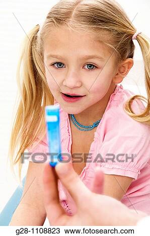 girl 7 with homeopathy blue tube View Large Photo Image Stock Image - girl 7 with homeopathy blue tube. Fotosearch