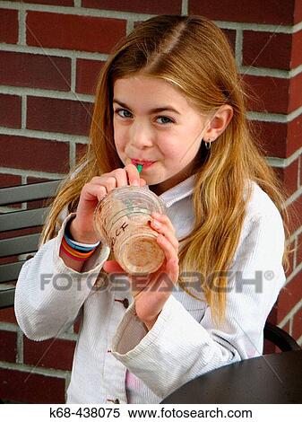 Stock Photography - Girl, 9, with drink.. Fotosearch