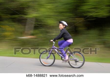 girl, 9 years old, rides a bicycle on a country road View Large Photo Image Stock Image - girl, 9 years old, rides a bicycle on a country road. Fotosearch