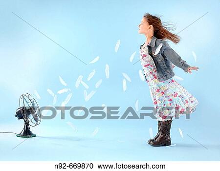 Girl, age 8 being blown by antique fan with feathers. View Large Photo Image Stock Image - Girl, age 8 being blown by antique fan with feathers.. Fotosearch